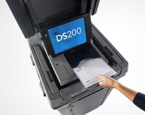 Picture of a ballot going into a DS200 ballot scanner.